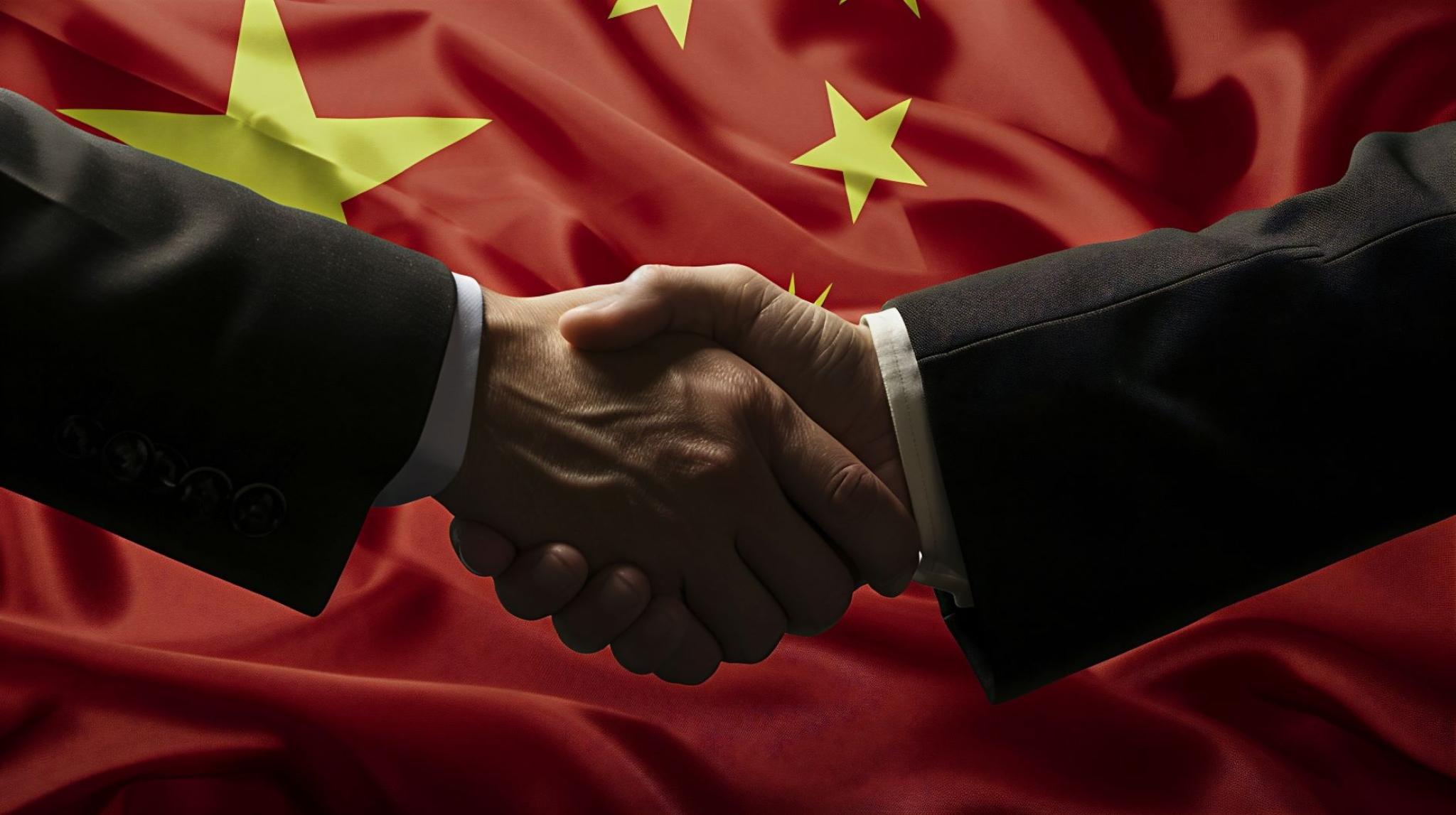 Image displaying two hands shaking with Chinese flag in the background