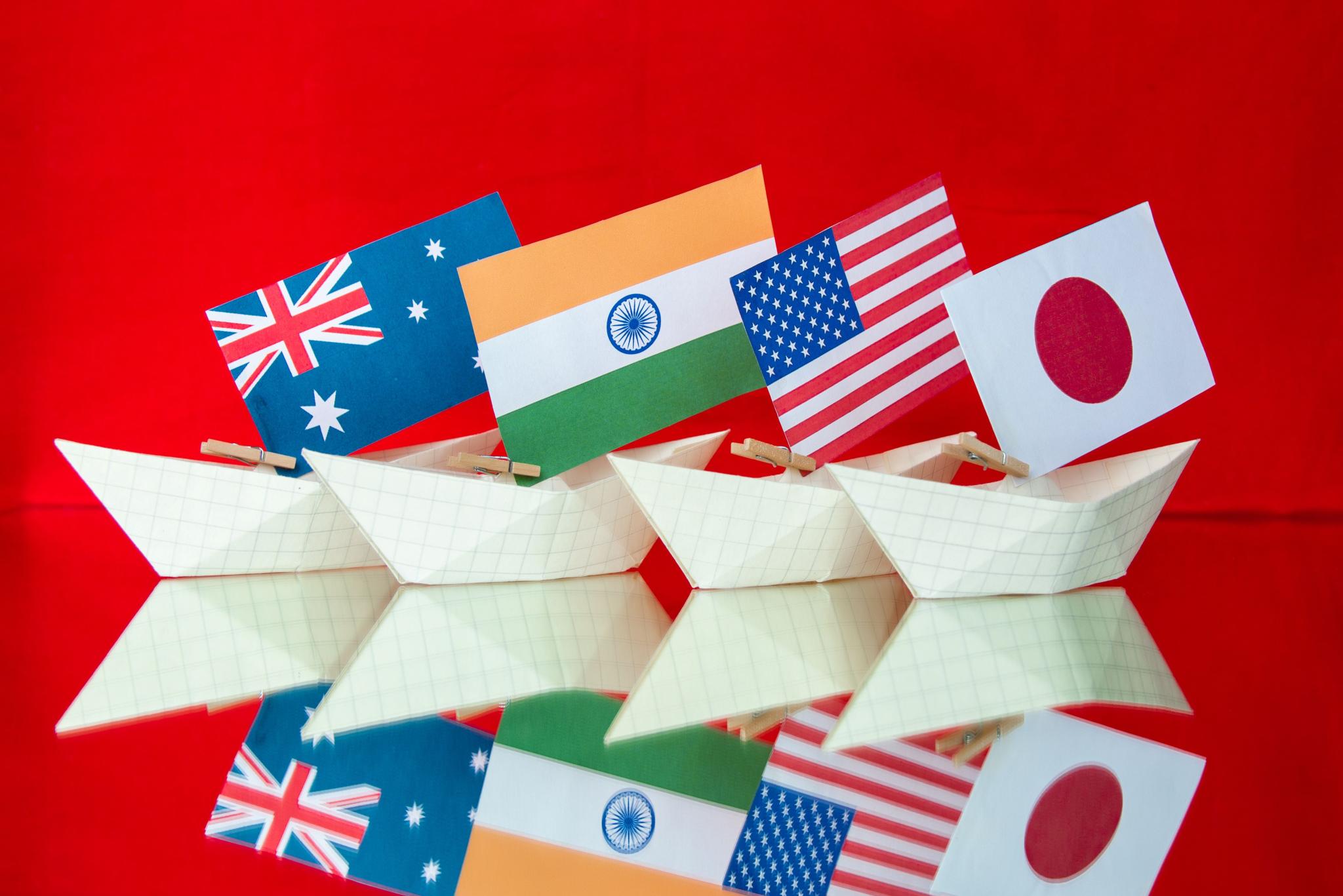 Australian, Indian, US and Japanese flags on paper boats