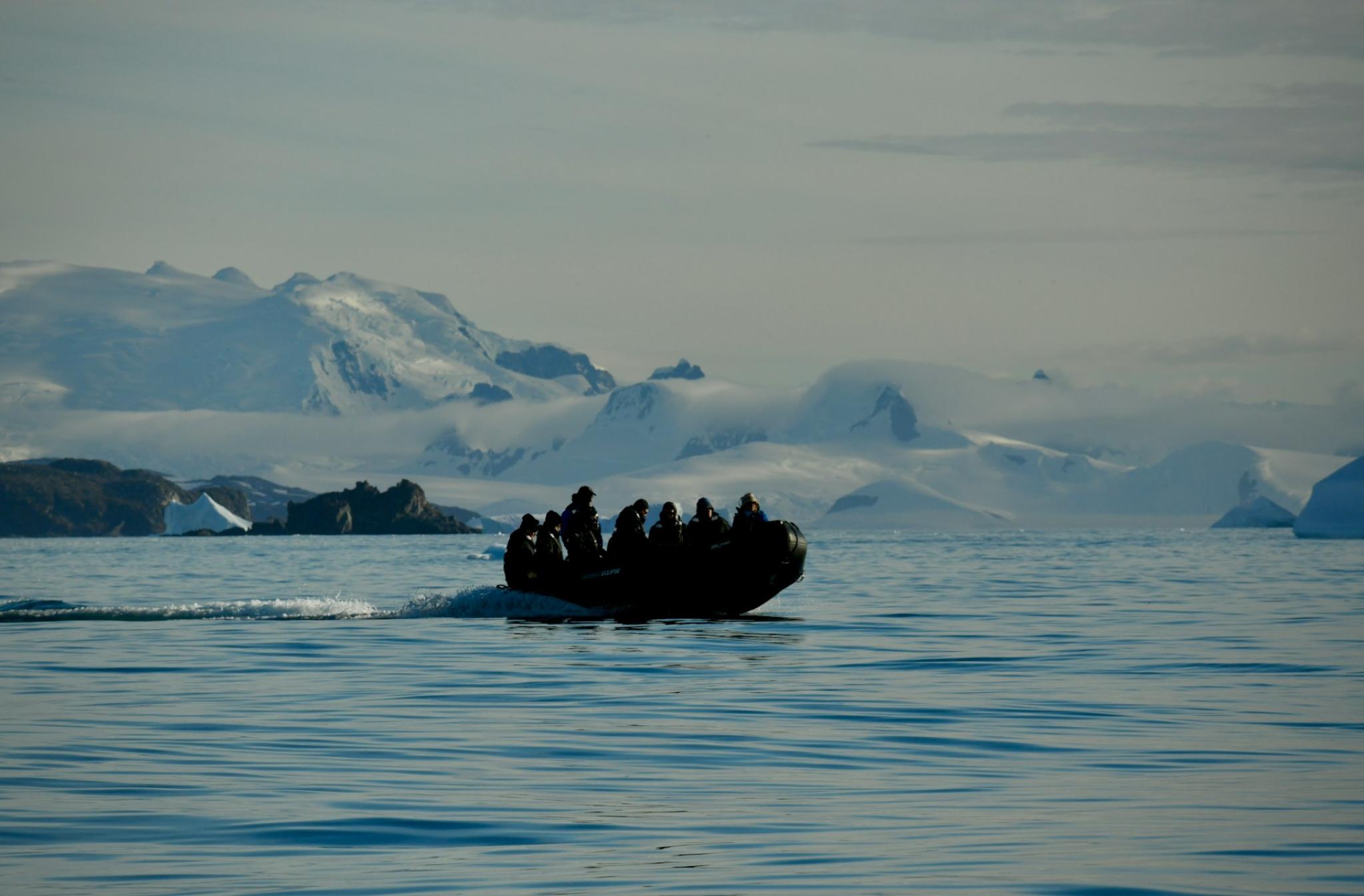 Boat in Antarctica with icebergs in the background