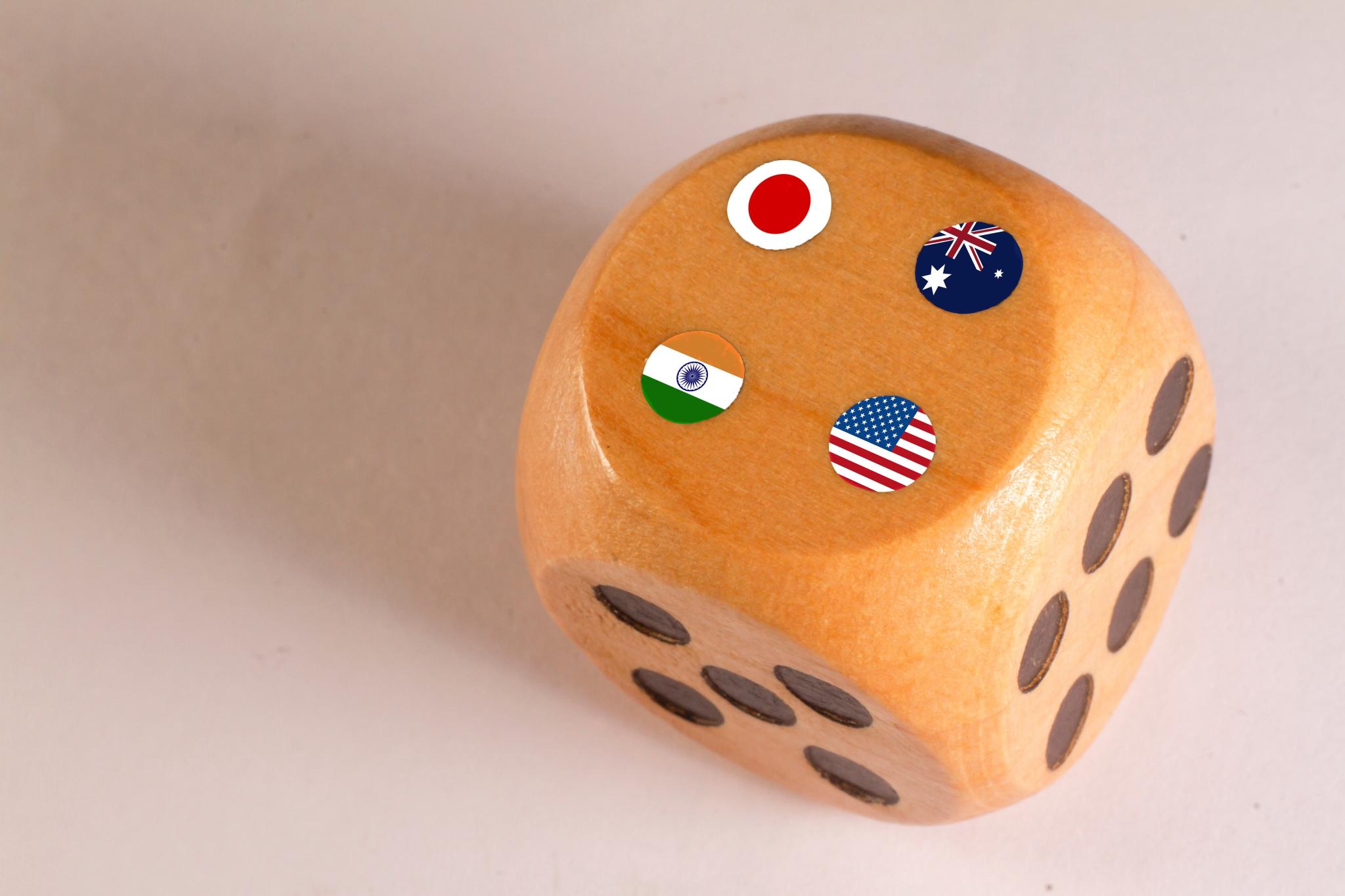 japan,australia,usa and india Quad plus countries flags paint over on wooden dice.